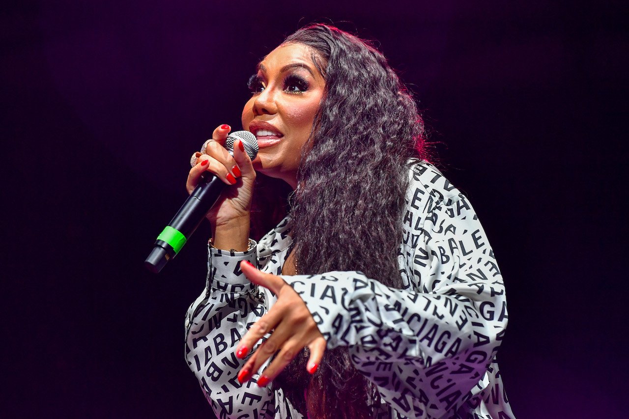 Tamar Braxton performs on stage; Braxton's new music release has been delayed