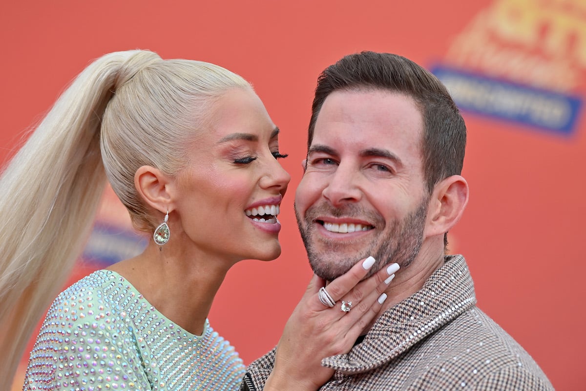 Heather Rae Young and Tarek El Moussa pose together at an event.