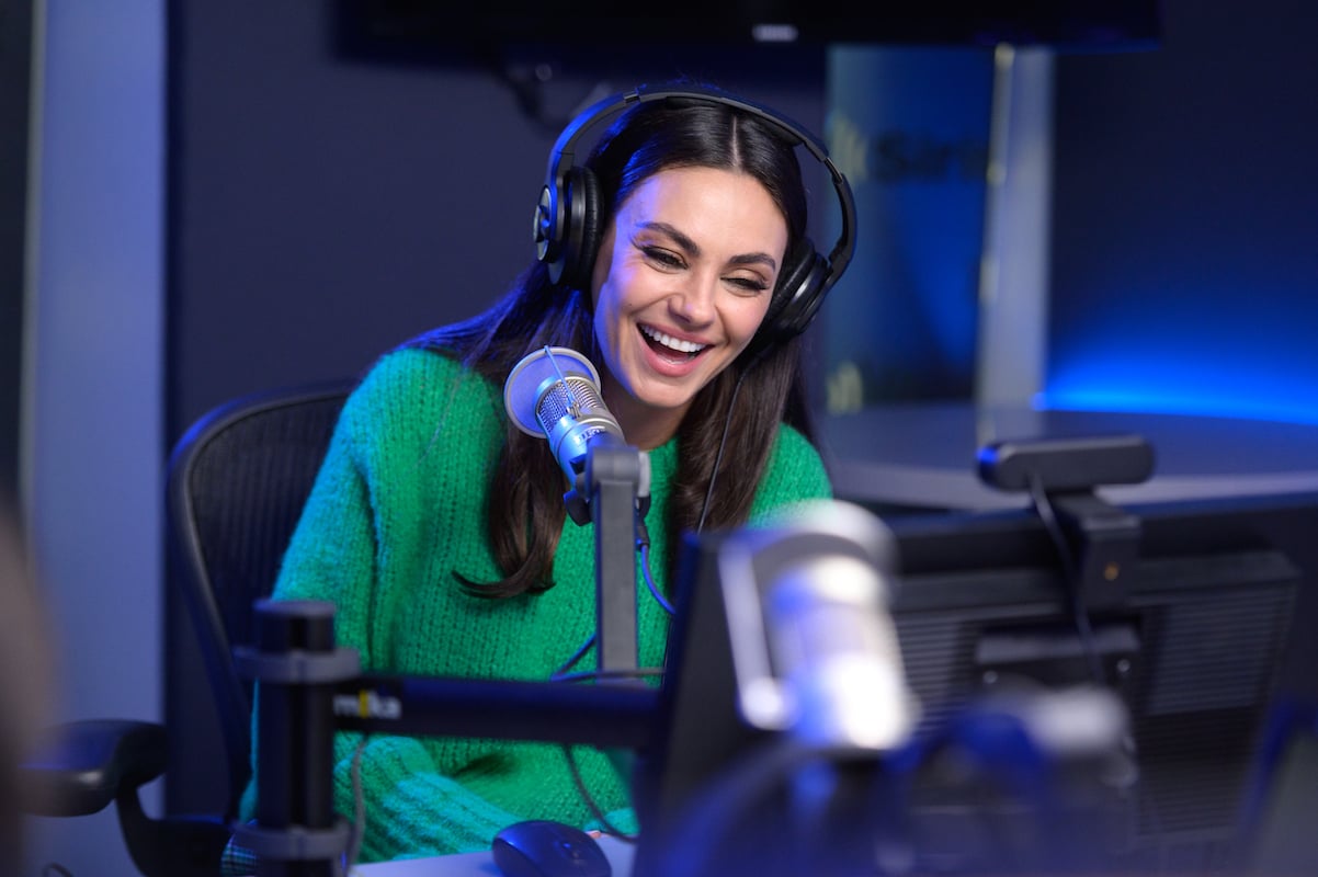 'That '90s Show' star Mila Kunis laughs into the Syrius studio microphone