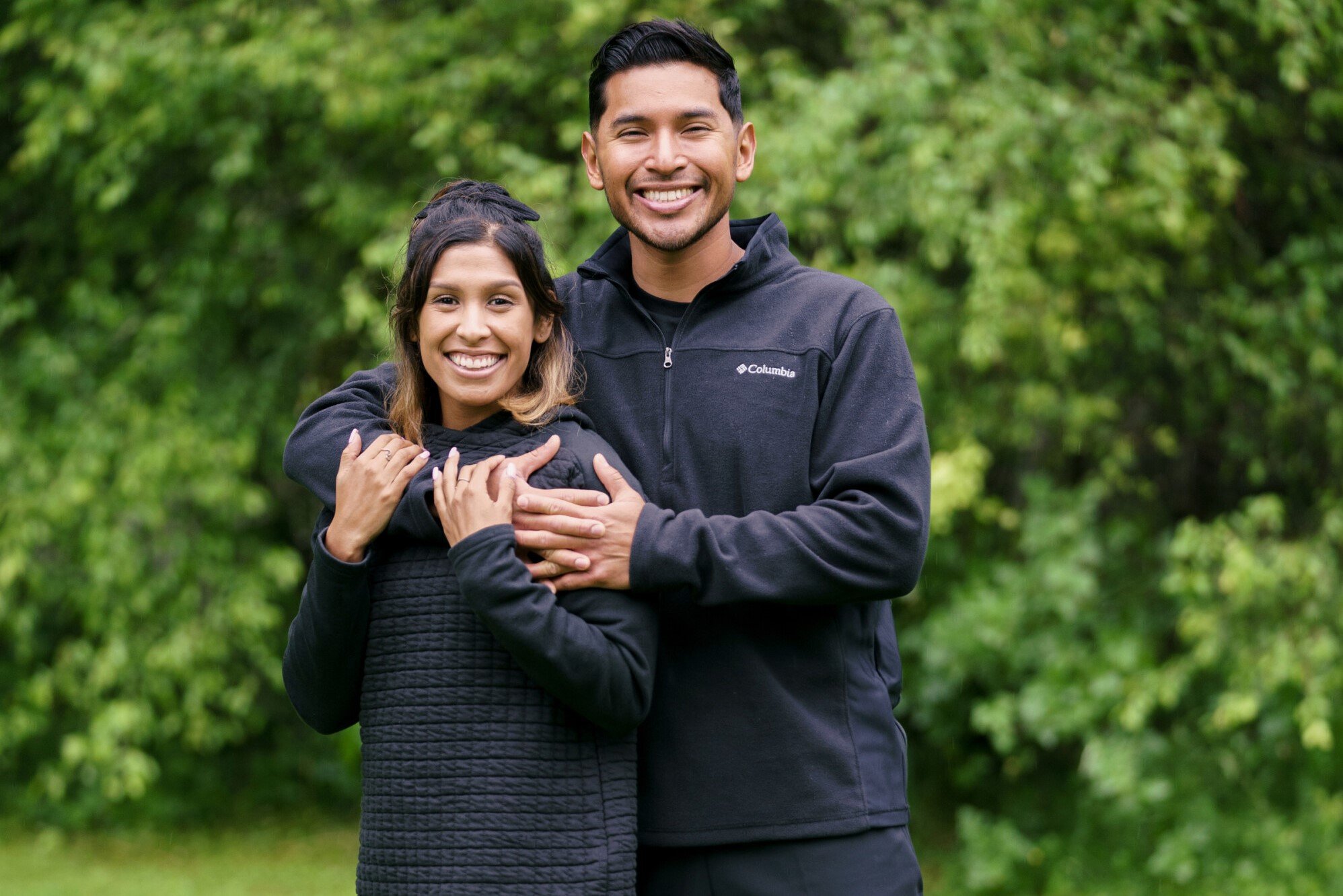 Aubrey Ares and David Hernandez, who are a part of the cast of 'The Amazing Race' Season 34 on CBS, wear black jackets and pose for promotional pictures.