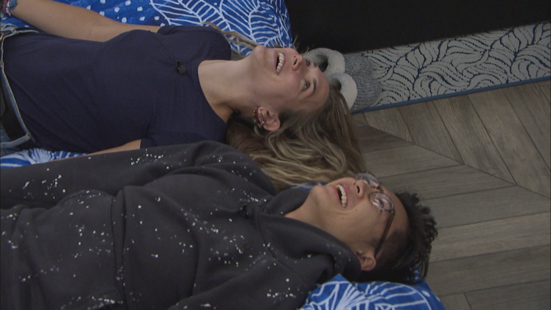 Claire Rehfuss and Derek Xiao laying down next to each other laughing during 'Big Brother 23'