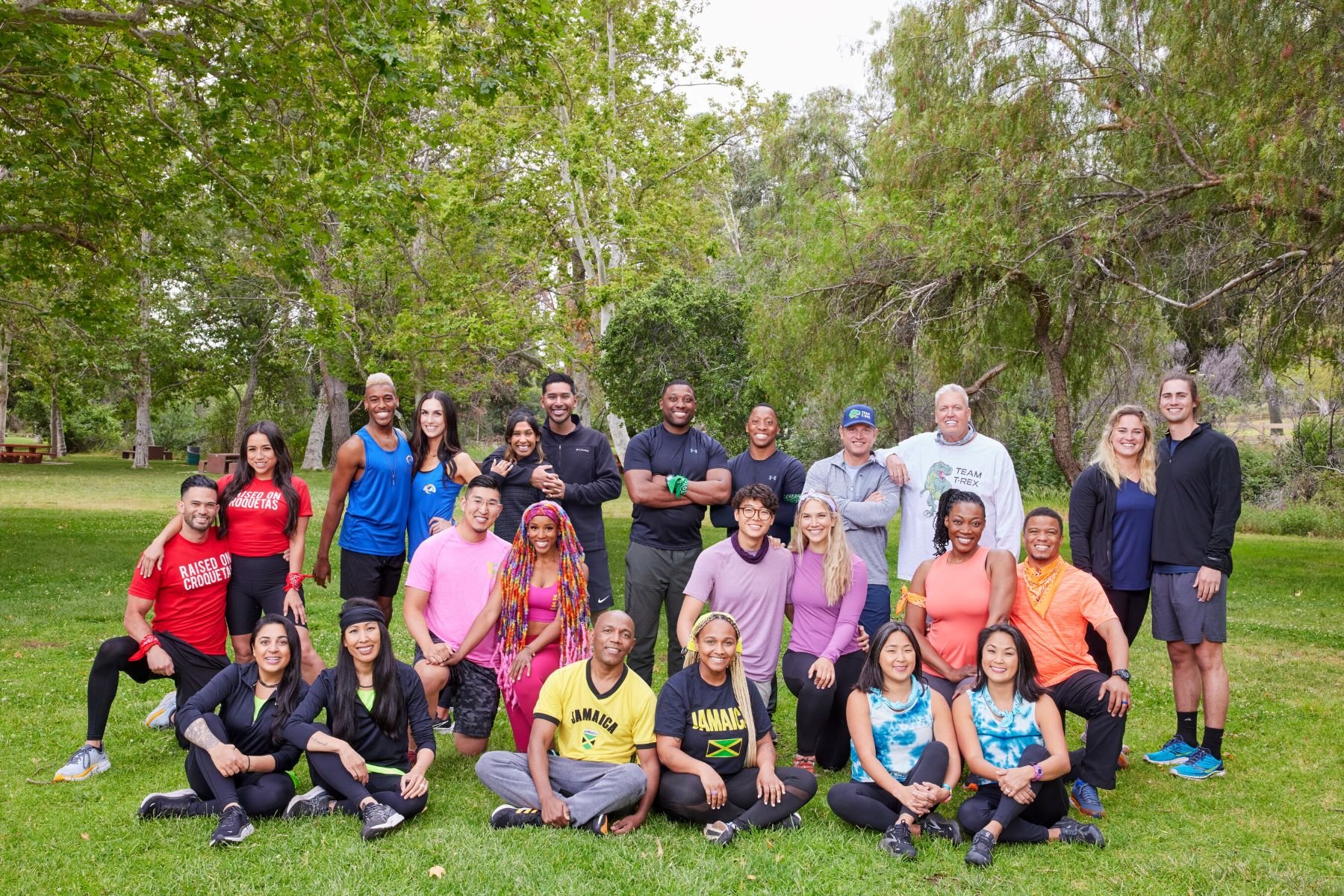 'The Amazing Race' Season 34 cast poses for a group picture in a park.