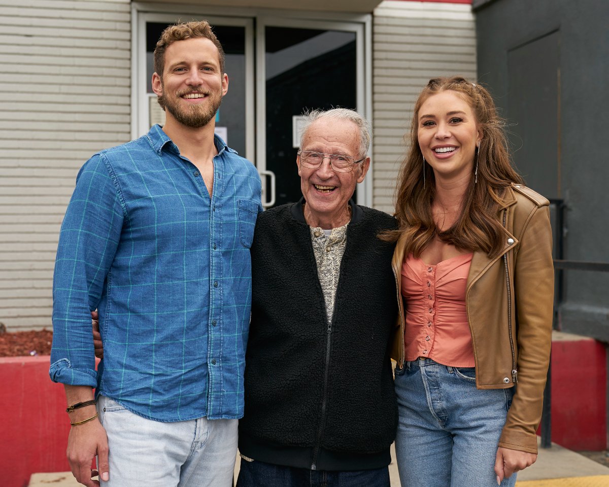 Erich Schwer from The Bachelorette poses with Gabby Windey and Grandpa John during a one-on-one date.