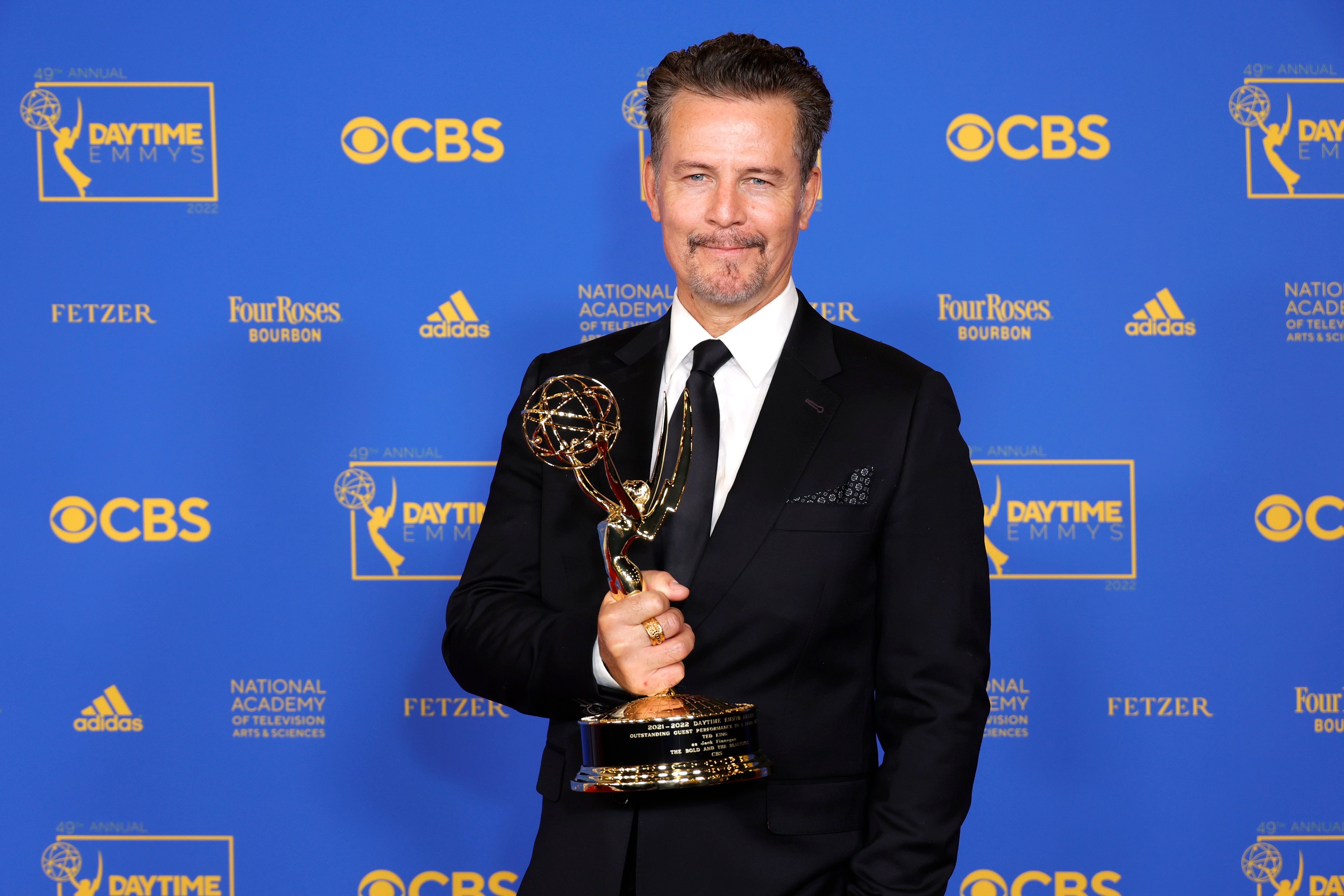 'The Bold and the Beautiful' star Ted King in a tuxedo and holding an Emmy.
