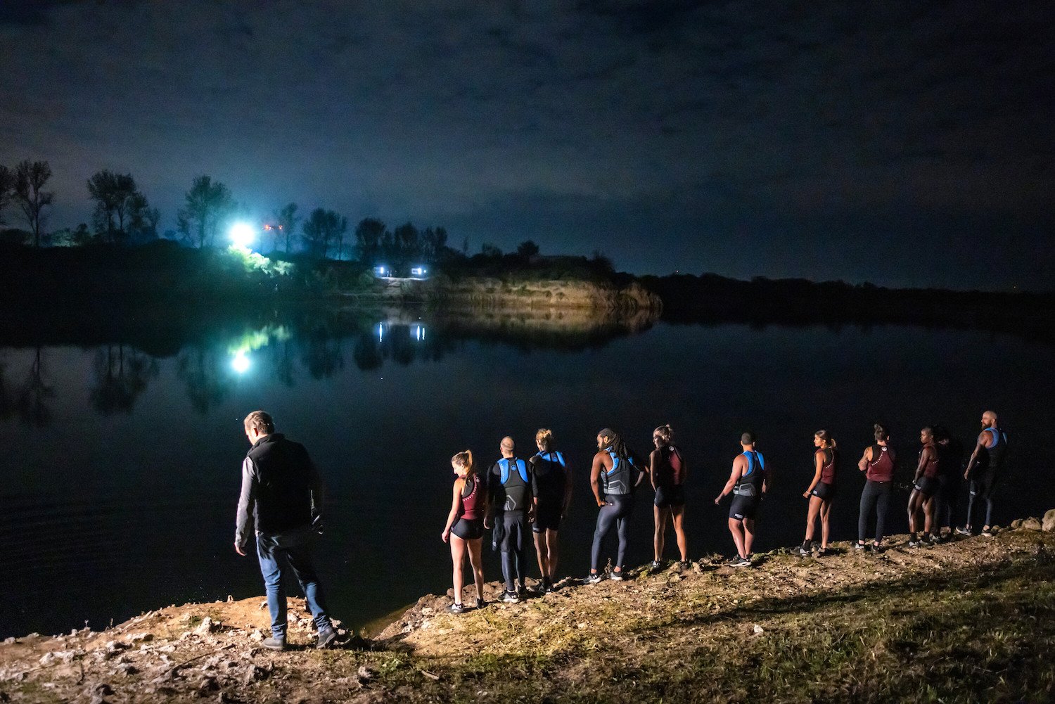 Competitors at night next to water in 'The Challenge: USA' final