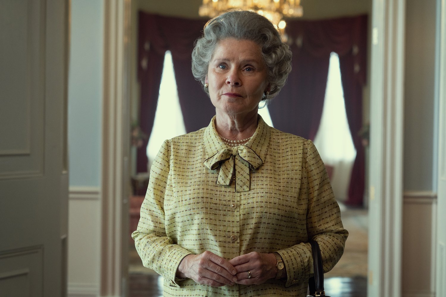 'The Crown' stars Imelda Staunton as Queen Elizabeth, seen here in a yellow dress in a production still