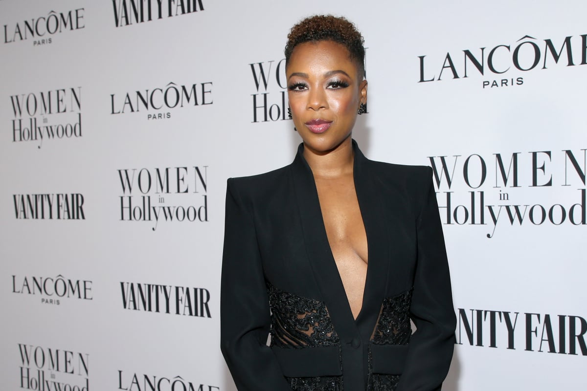 The Handmaid's Tale star Samira Wiley wears a low-cut black blazer and black earrings.