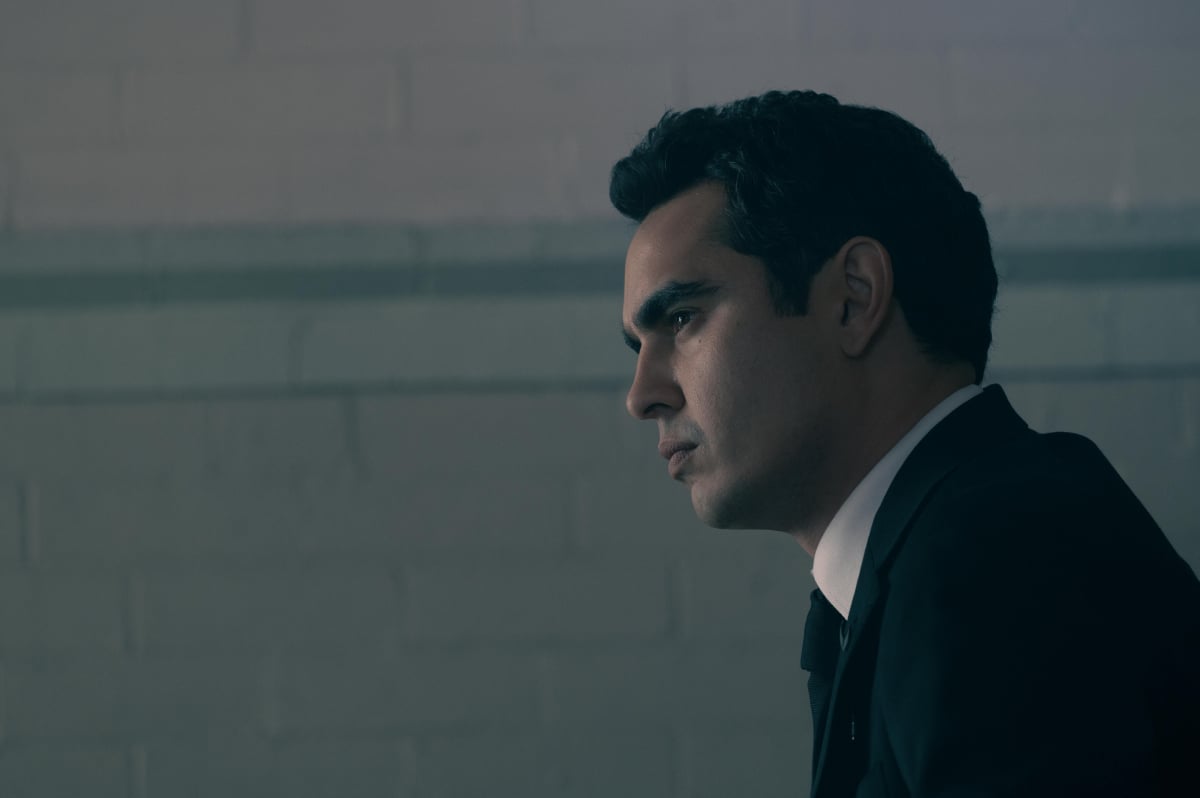 Max Minghella as Nick in The Handmaid's Tale Season 5. Nick wears a suit and tie.