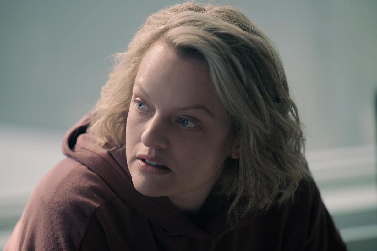 Elisabeth Moss as June Osborne in The Handmaid's Tale Season 5. June wears a maroon hoodie.