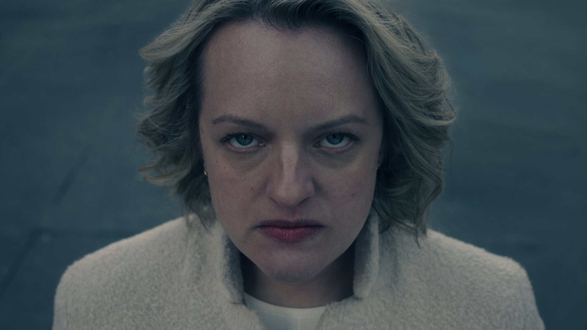 Elisabeth Moss as June in 'The Handmaid's Tale' Season 5 for our article about the episode 1 premiere release date and time. She's staring into the camera and looks angry.