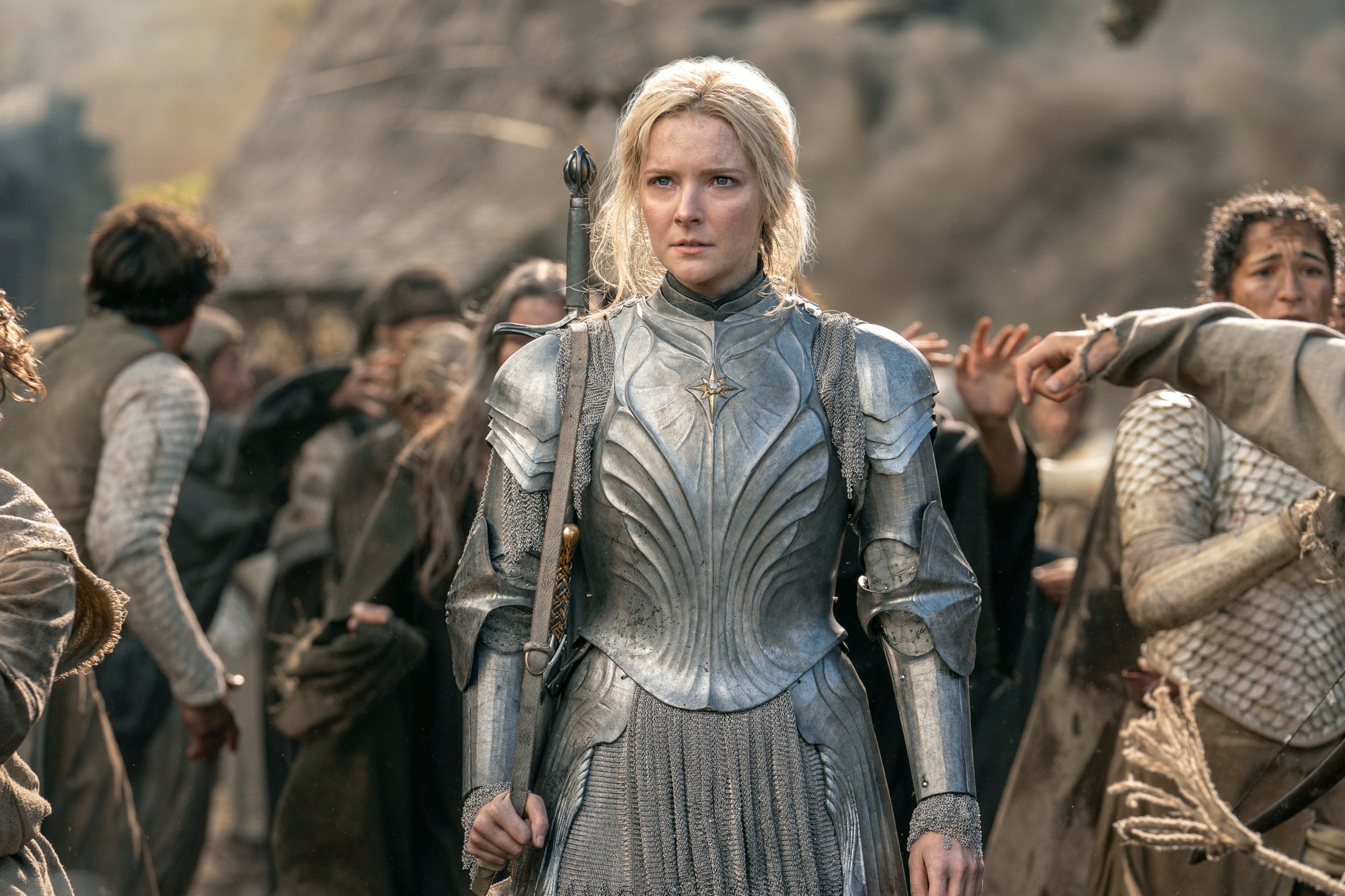 Morfydd Clark as Galadriel in 'The Lord of the Rings: The Rings of Power' for our article covering its episode count and release schedule. Her blonde hair is pulled back, and she's wearing armor.