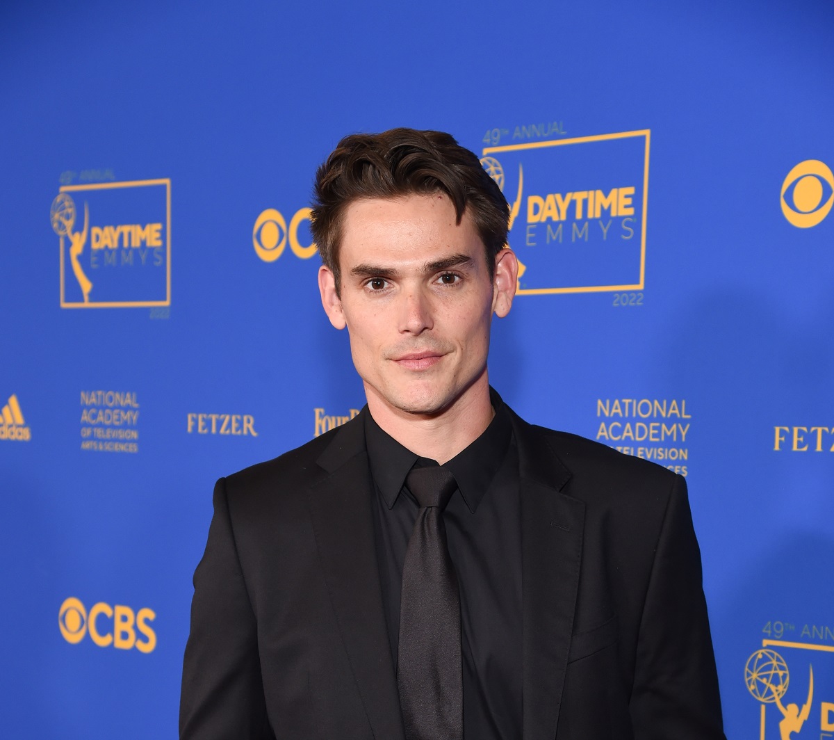 'The Young and the Restless' star Mark Grossman wearing a black suit and posing on the red carpet of the 2022 Daytime Emmys.