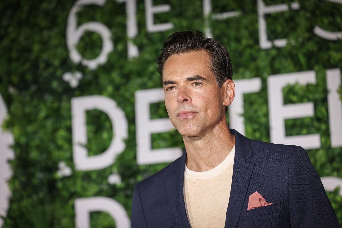 'The Young and the Restless' star Jason Thompson in a blue suit and white shirt poses for photographers at the Monte Carlo TV Festival.