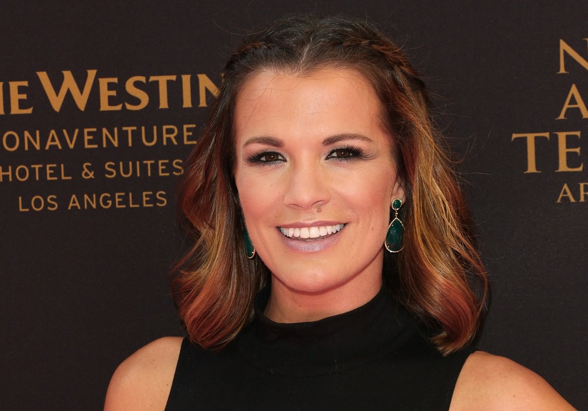 'The Young and the Restless' star Melissa Claire Egan in a black dress poses for a photo during the 2016 Daytime Emmys.