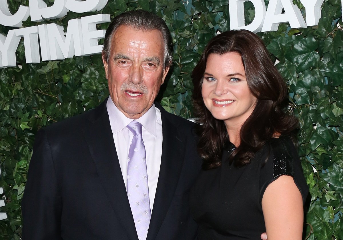 'The Young and the Restless' star Eric Braeden in a suit and Heather Tom in a black dress, pose together for a photo.