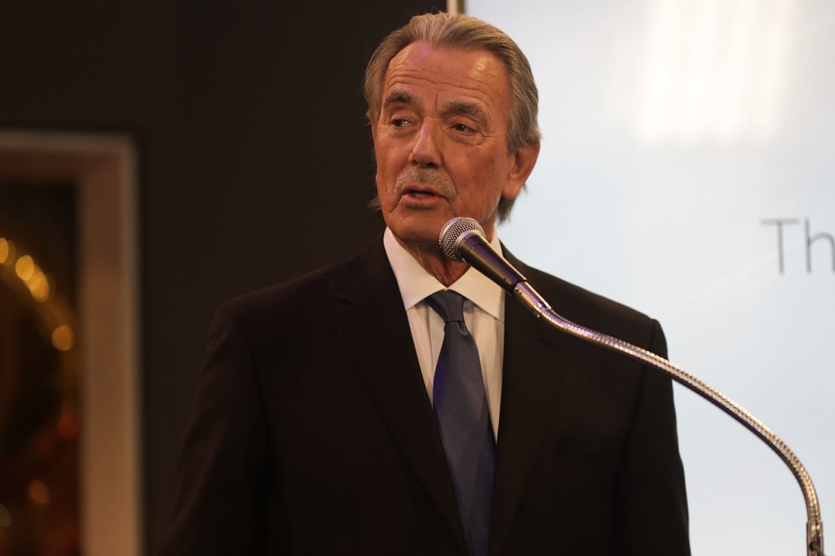 'The Young and the Restless' star Eric Braeden in a black suit stands in front of a microphone.