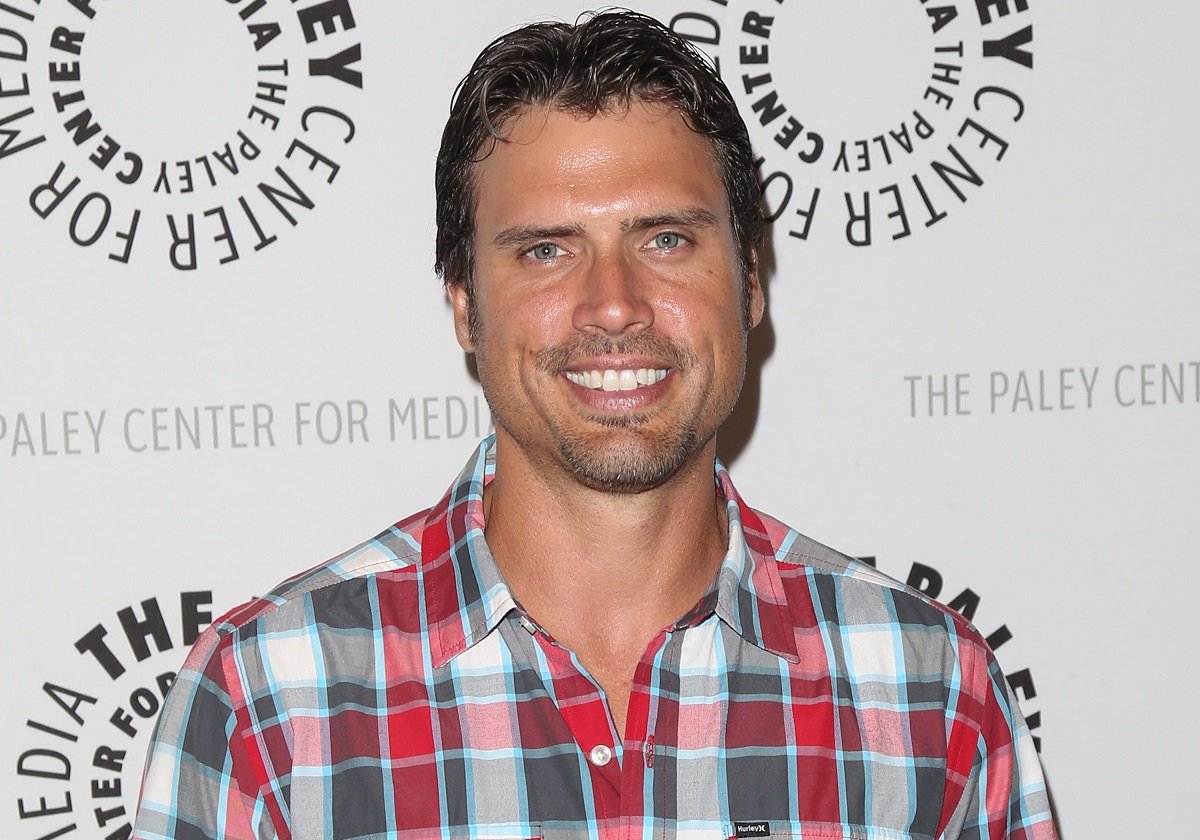 'The Young and the Restless' star Joshua Morrow in a red and blue plaid shirt; smiles for the camera.