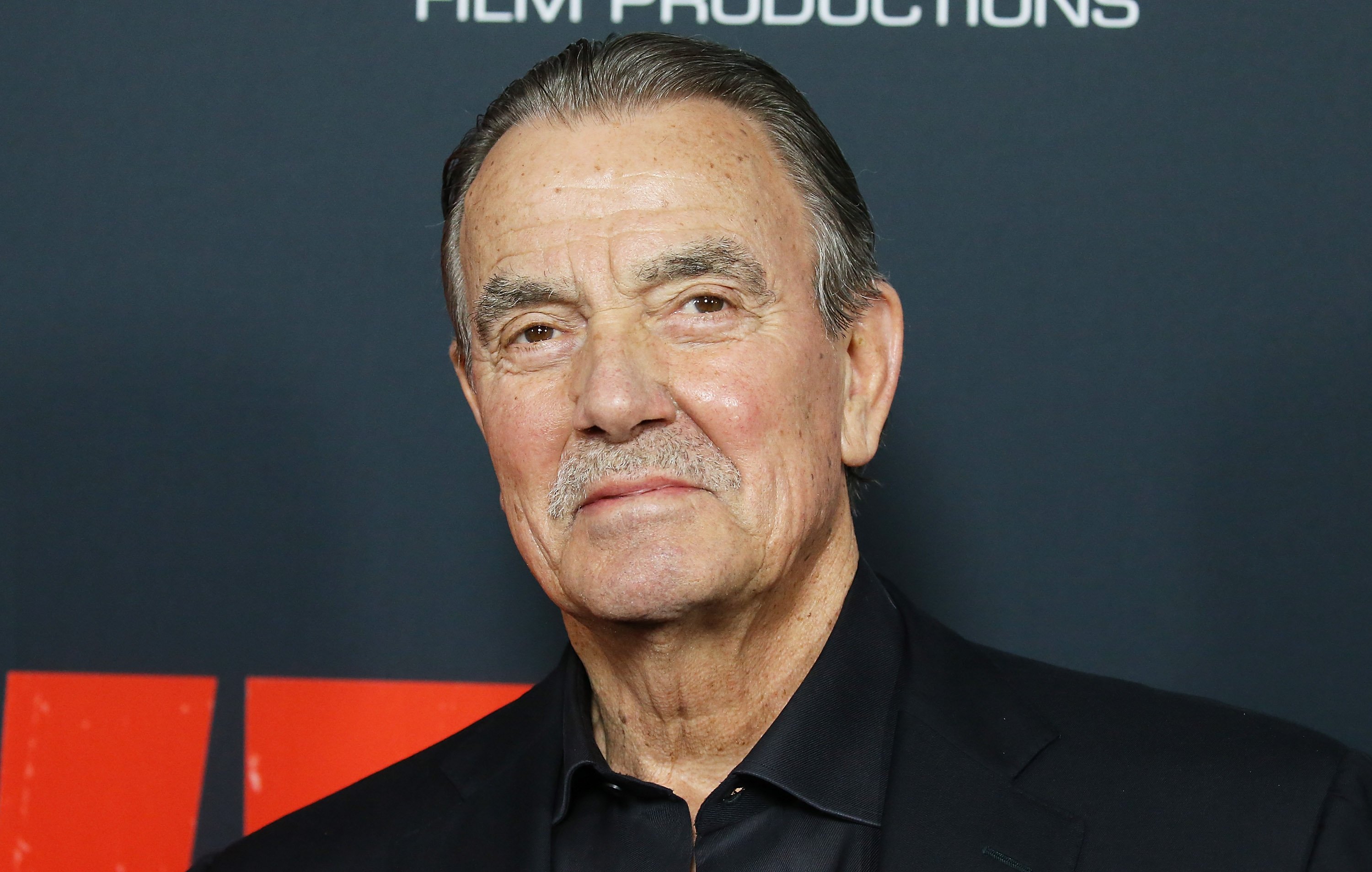'The Young and the Restless' star Eric Braeden in a black suit, poses on the red carpet.