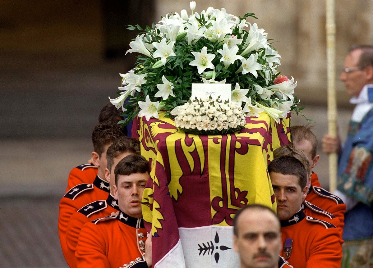 The coffin of Princess Diana with flowers and a card on top from Prince Harry