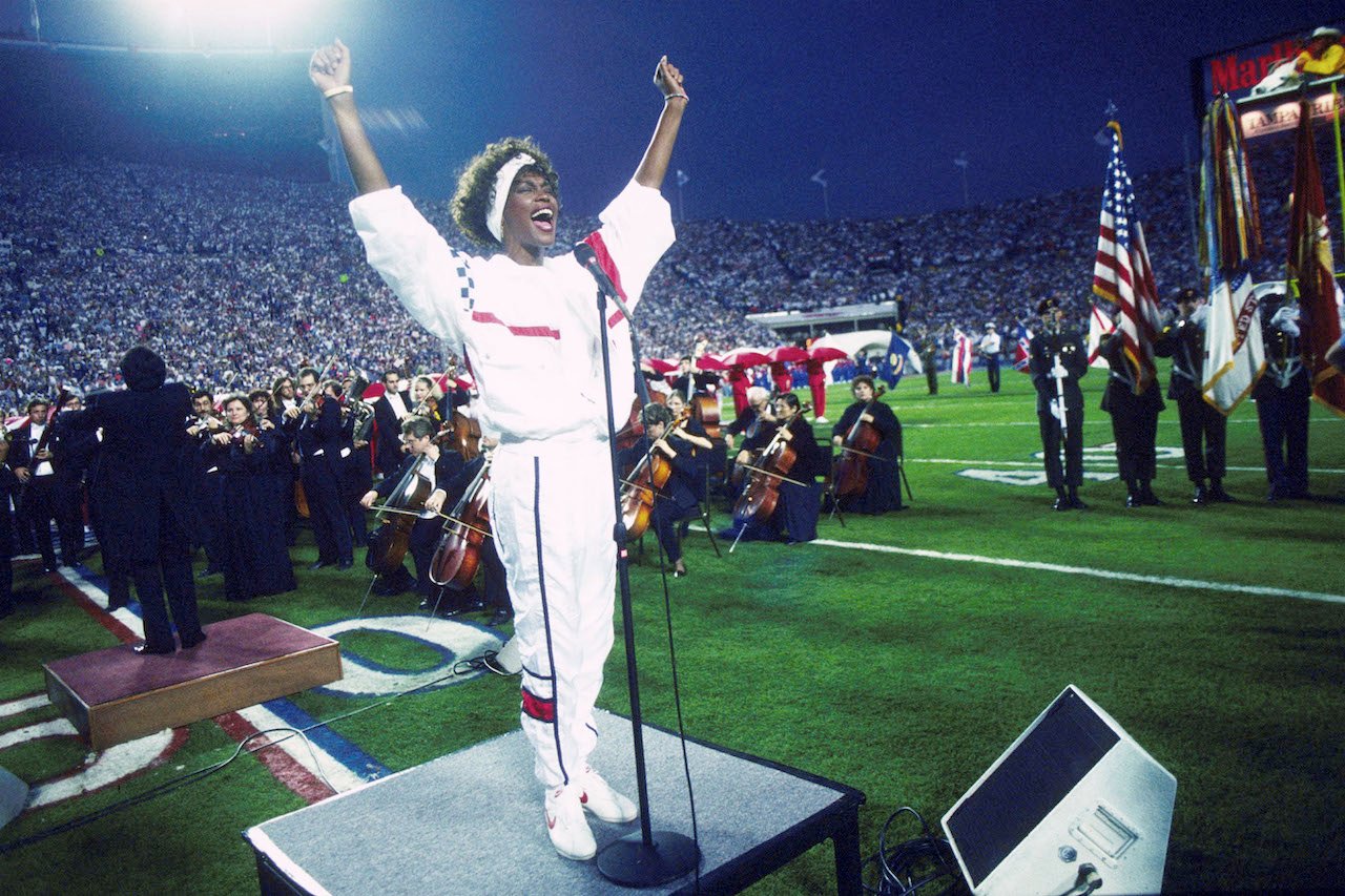Whitney Houston performs at the 1991 Super Bowl Half Time show; Houston's biopic has split fan reactions