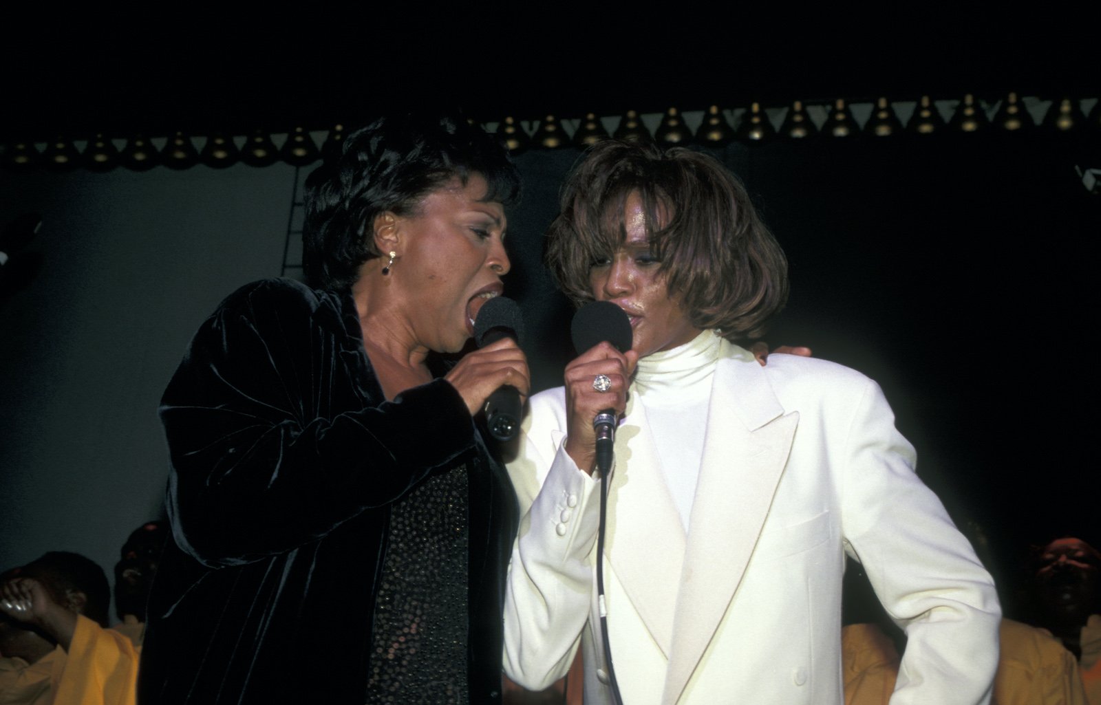 Jenifer Lewis and Whitney Houston sing together in microphones