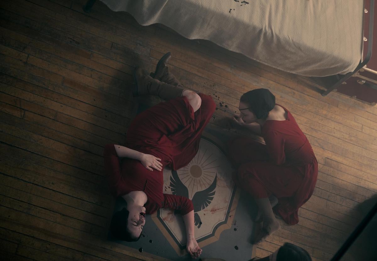 Esther (McKenna Grace) and Janine (Madeline Brewer) choke on poisoned chocolates in 'The Handmaid's Tale' Season 5 Episode 2 'Ballet'