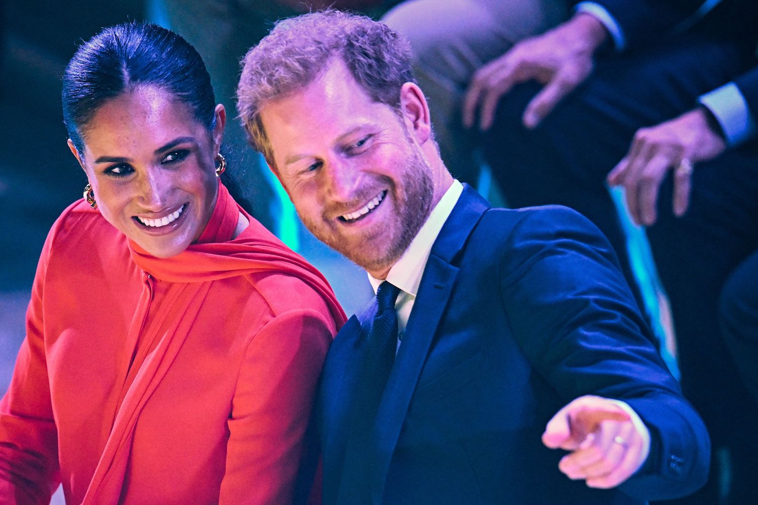 Meghan Markle body language as seen at One Young World summit where she wore a red outfit alongside Prince Harry in a suit