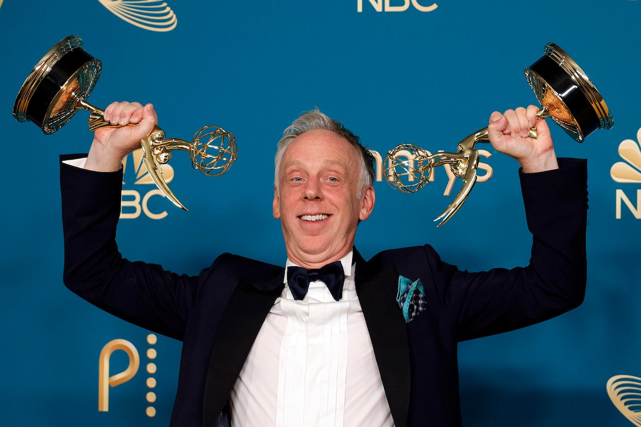 Mike White, who has several credits for movies and tv shows, holding his Emmy Awards