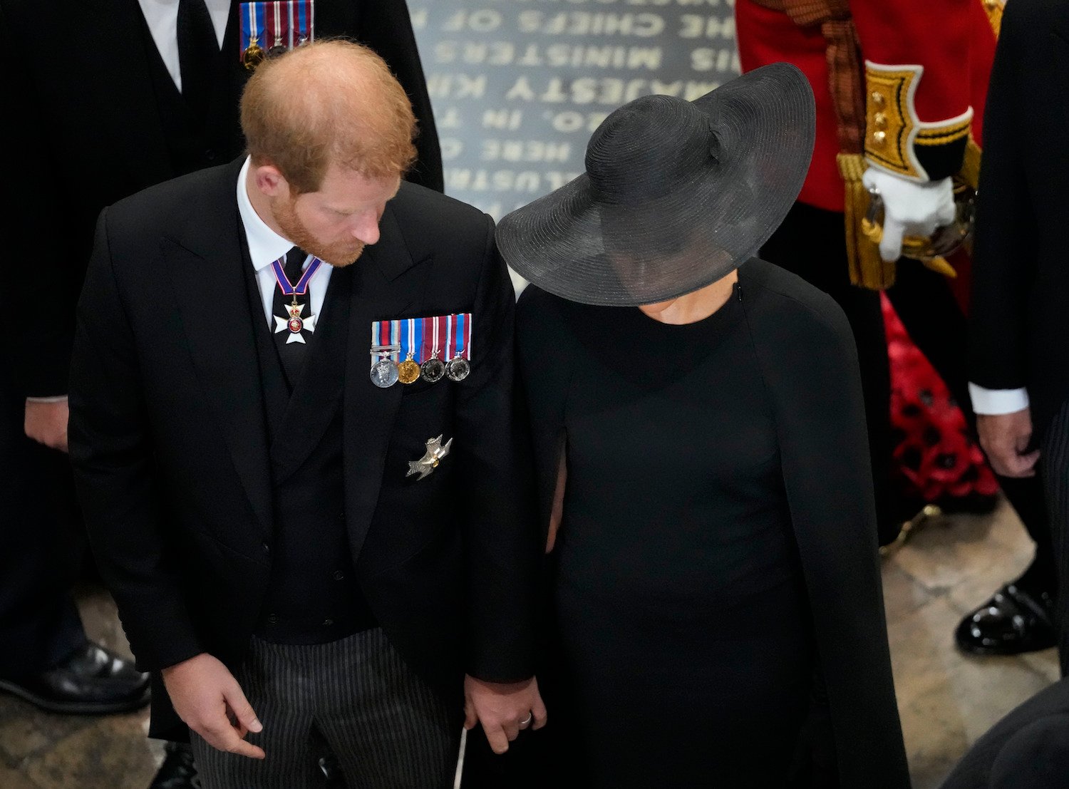 Prince Harry and Meghan Markle body language at Queen Elizabeth funeral when they touched hands