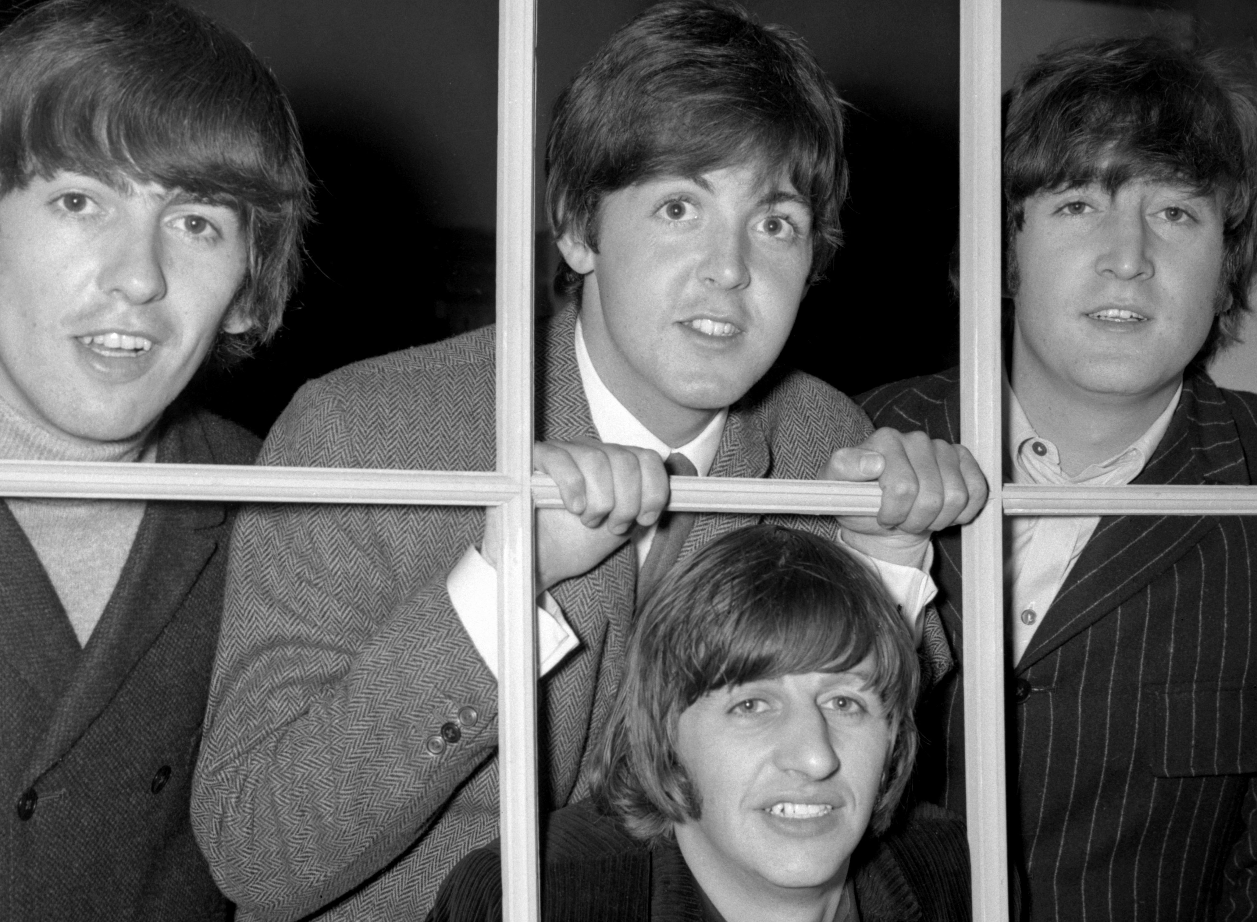 The Beatles at a window during the 'Rubber Soul' era