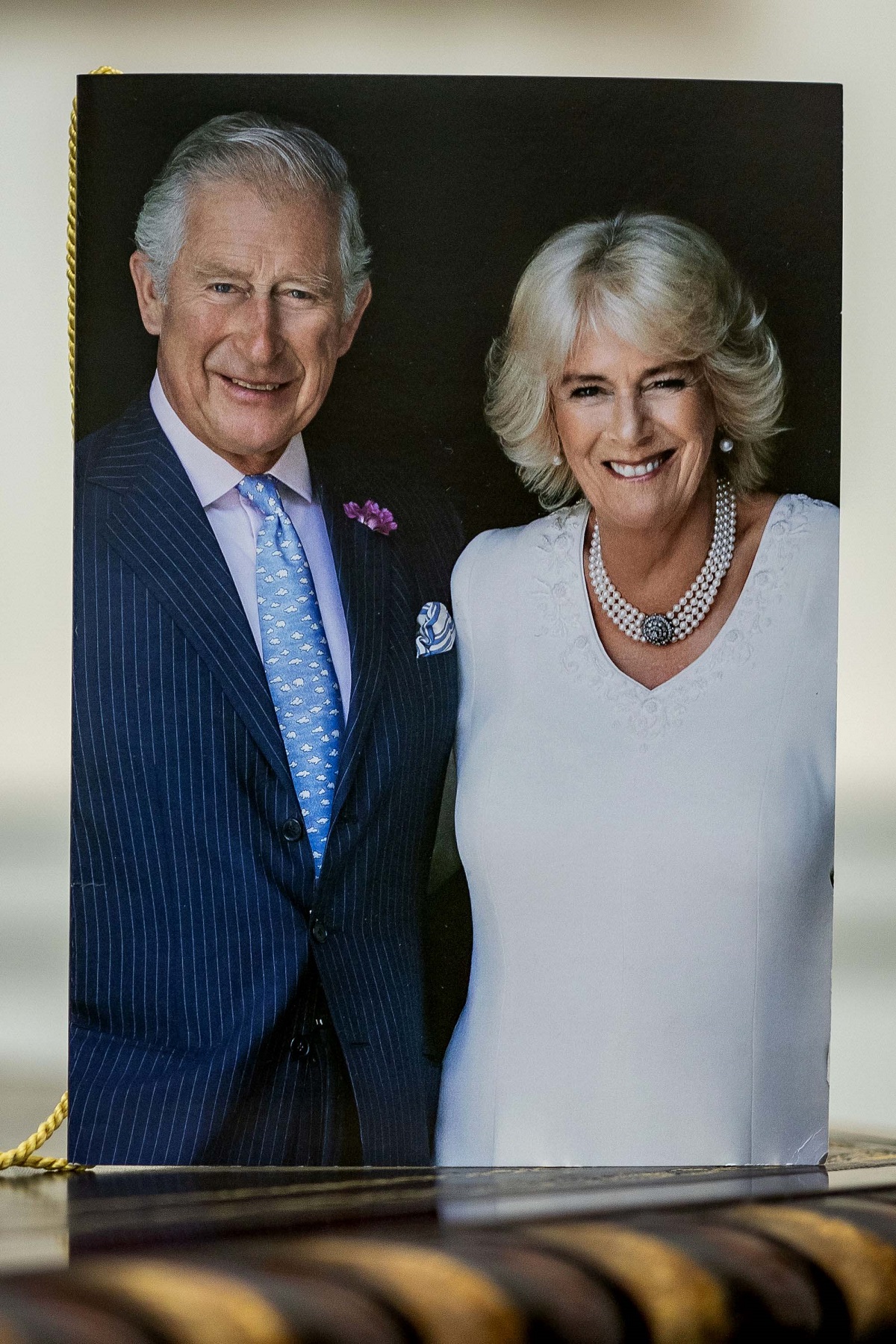 A close-up of the front of one of the first birthday cards celebrating 100 years of age, which have been signed by King Charles III and Camilla Parker Bowles