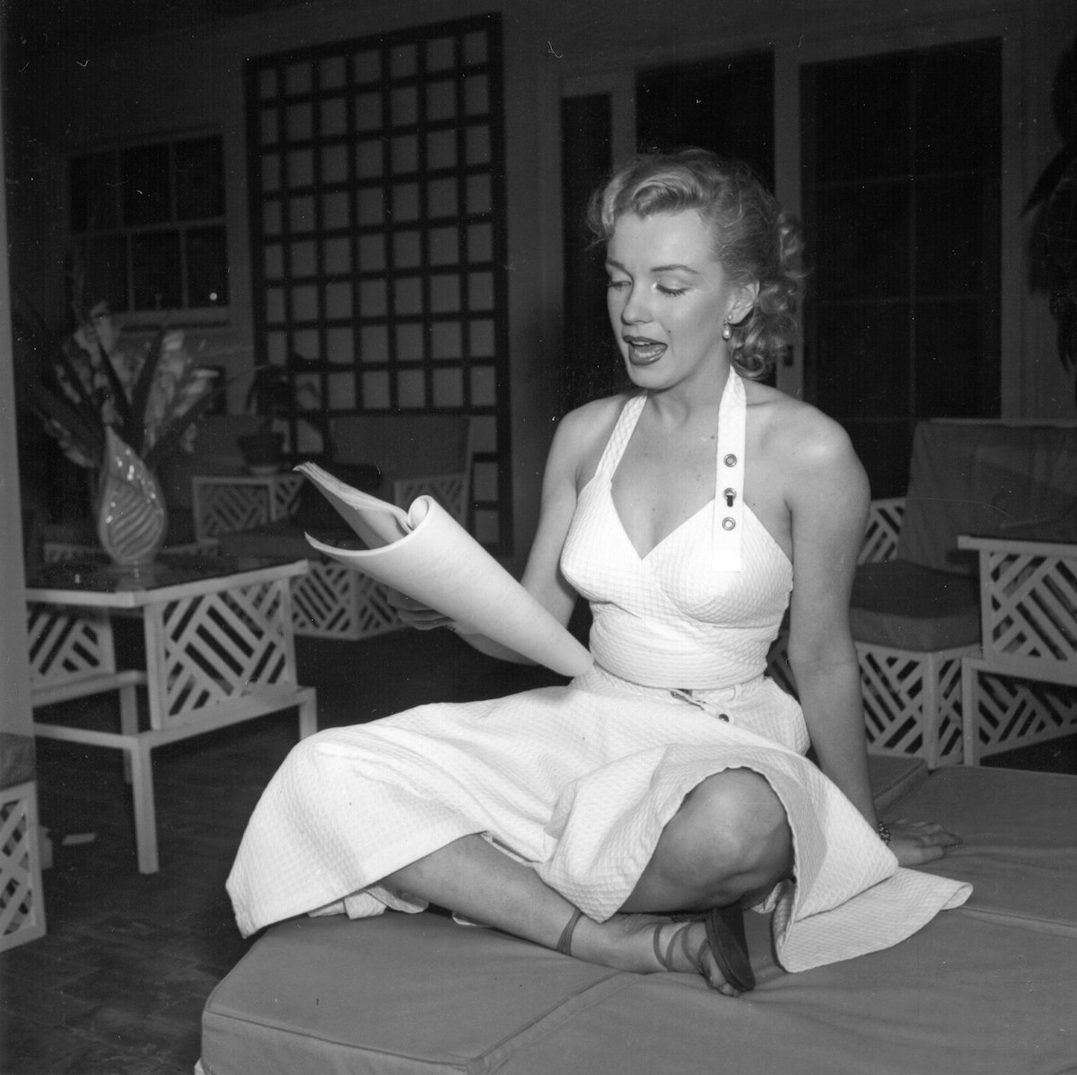 Actor Marilyn Monroe reads a script at Hollywood agent Johnny Hyde's house in Beverly Hills
