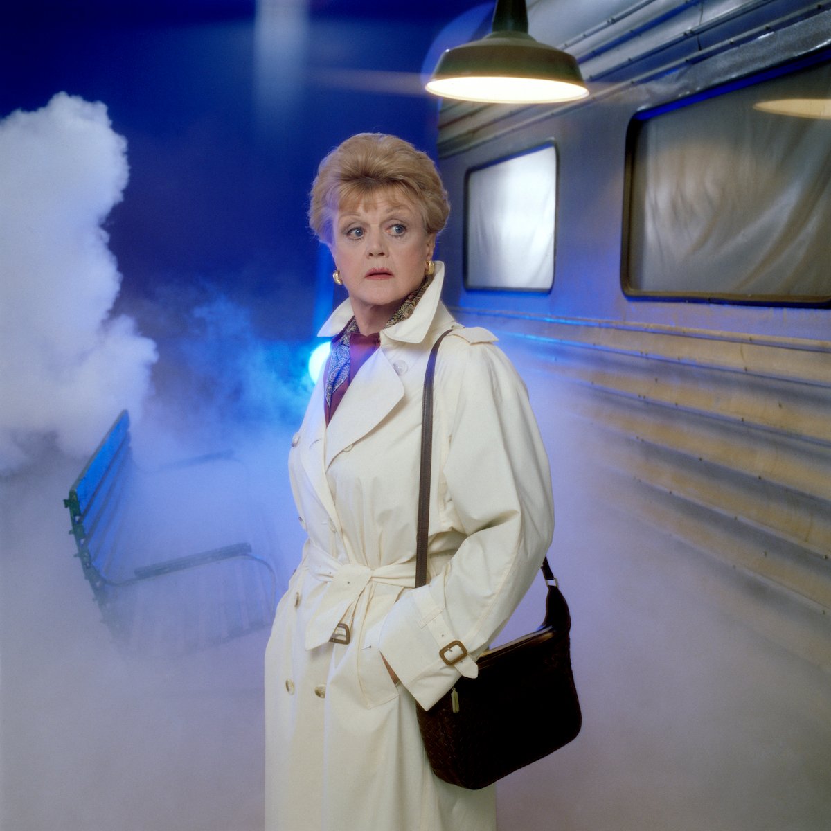 Angela Lansbury as Jessica Fletcher wearing a trench coat in a promotional shot for 'Murder, She Wrote'