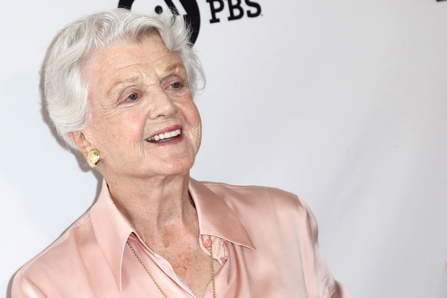 Angela Lansbury wearing a light peach colored top. Angela Lansbury dead in 2022.