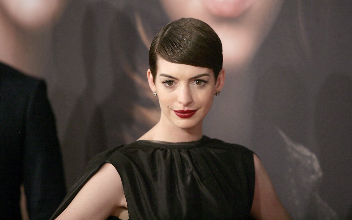 Actress Anne Hathaway attends the "Les Miserables" New York Premiere in a black dress and short hair