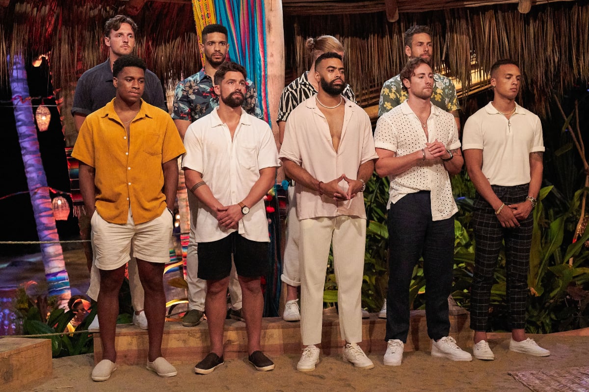 On Bachelor in Paradise Season 8, Logan Palmer, Romeo Alexander, Jacob Rapini, Casey Woods, Andrew Spencer, Michael Allio, Justin Glaze, Johnny DePhillipo, and Brandon Jones stand waiting at a rose ceremony.