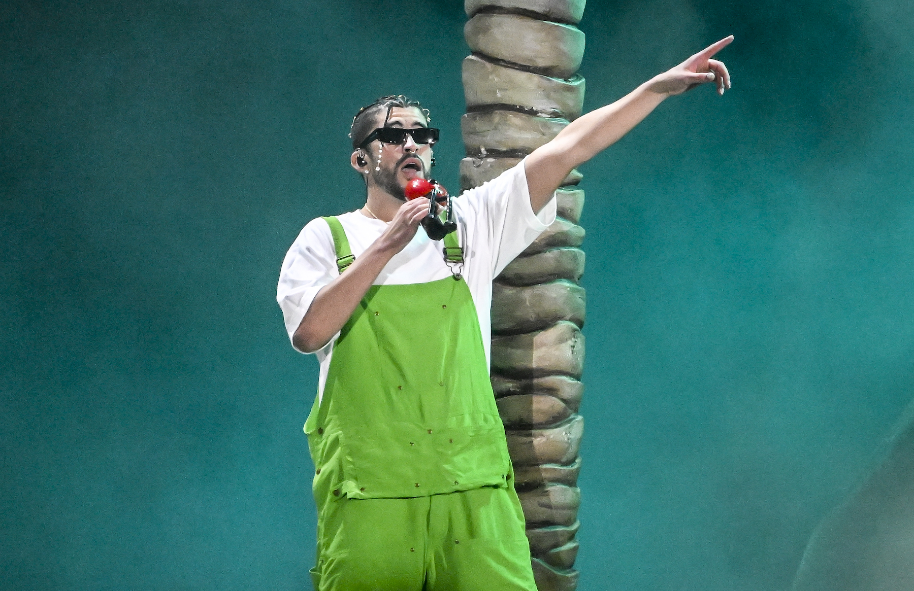 Bad Bunny, who is nominated for 8 AMAs, performing wearing green