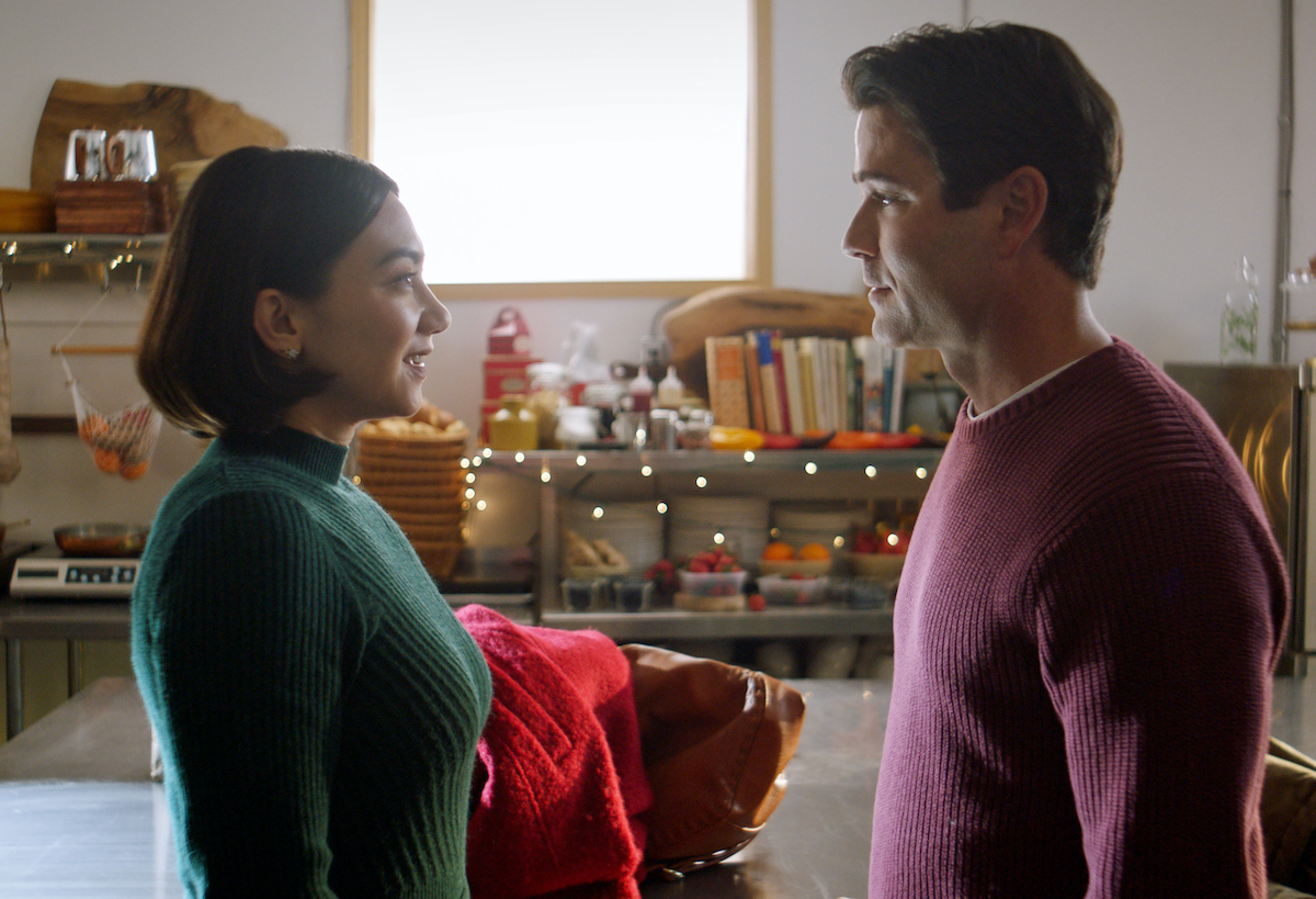 Woman and man facing each other in the Lifetime Christmas movie 'Baking all the Way'