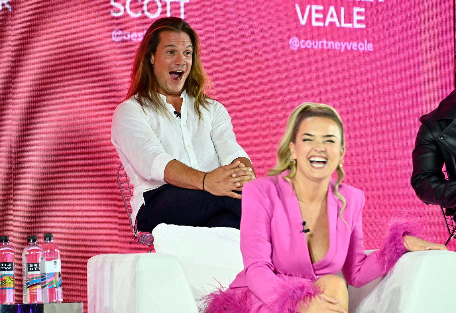 Gary King from 'Below Deck Sailing Yacht' sits behind Daisy Kelliher looking surprised as she laughs at BravoCon
