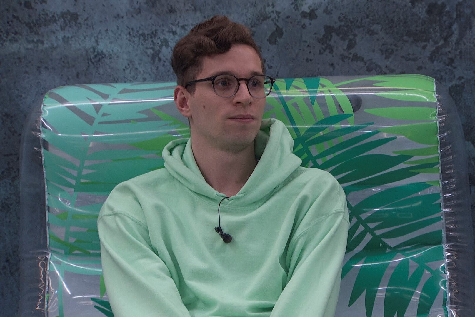 Michael Bruner, who starred in 'Big Brother 24' on CBS, wears a mint green hoodie and glasses.