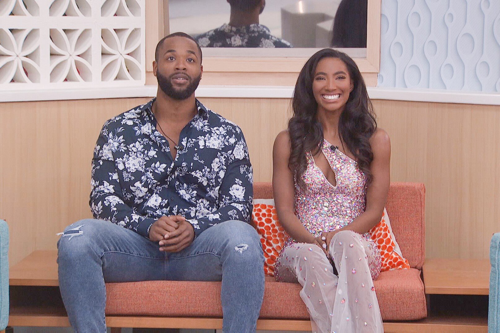 Monte Taylor and Taylor Hale, who starred in 'Big Brother 24' on CBS, sit in the final two chairs. Monte wears a dark blue long-sleeved button-up shirt and jeans. Taylor wears a light pink bejeweled jumpsuit.