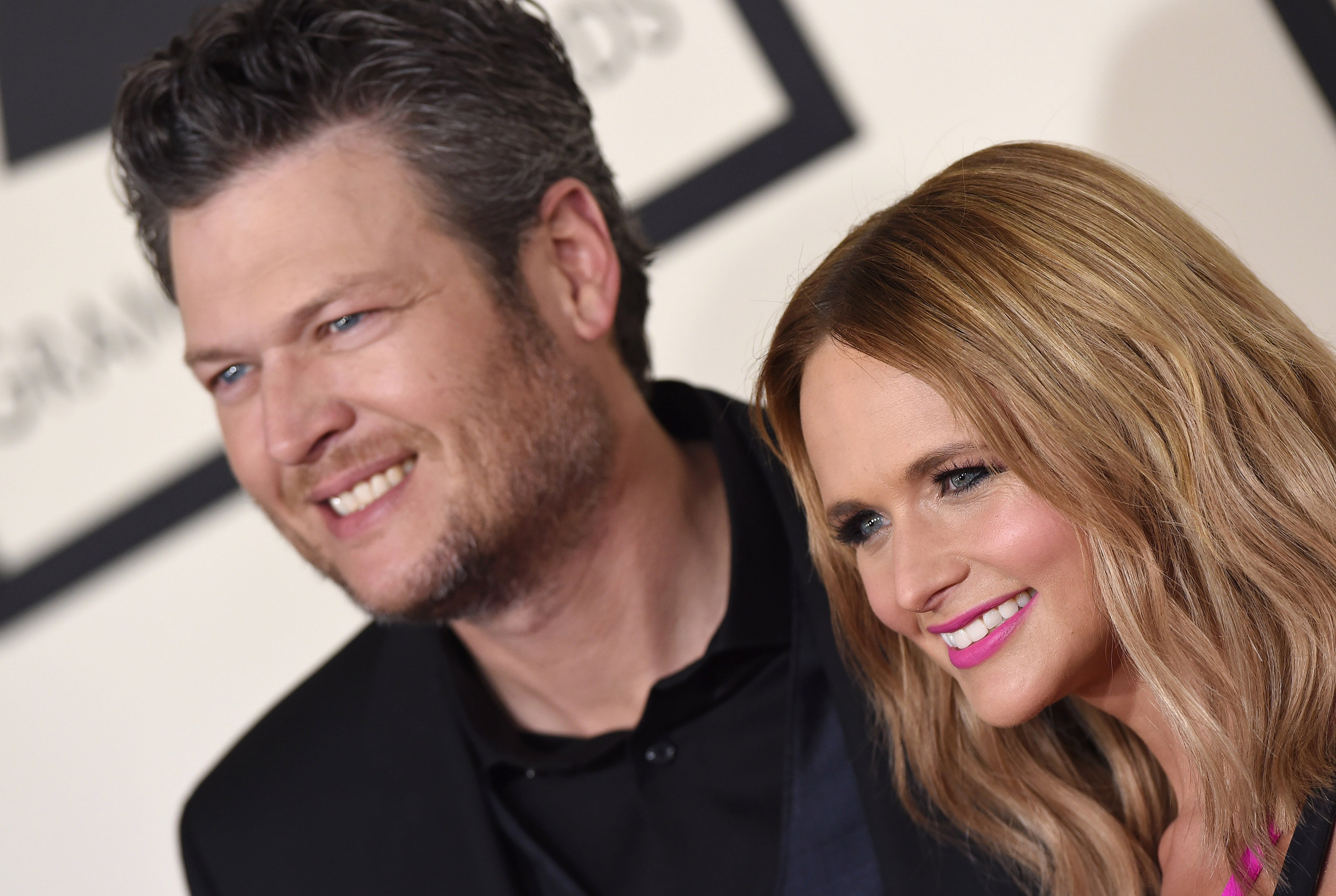 Blake Shelton and Miranda Lambert smile while standing next to each other