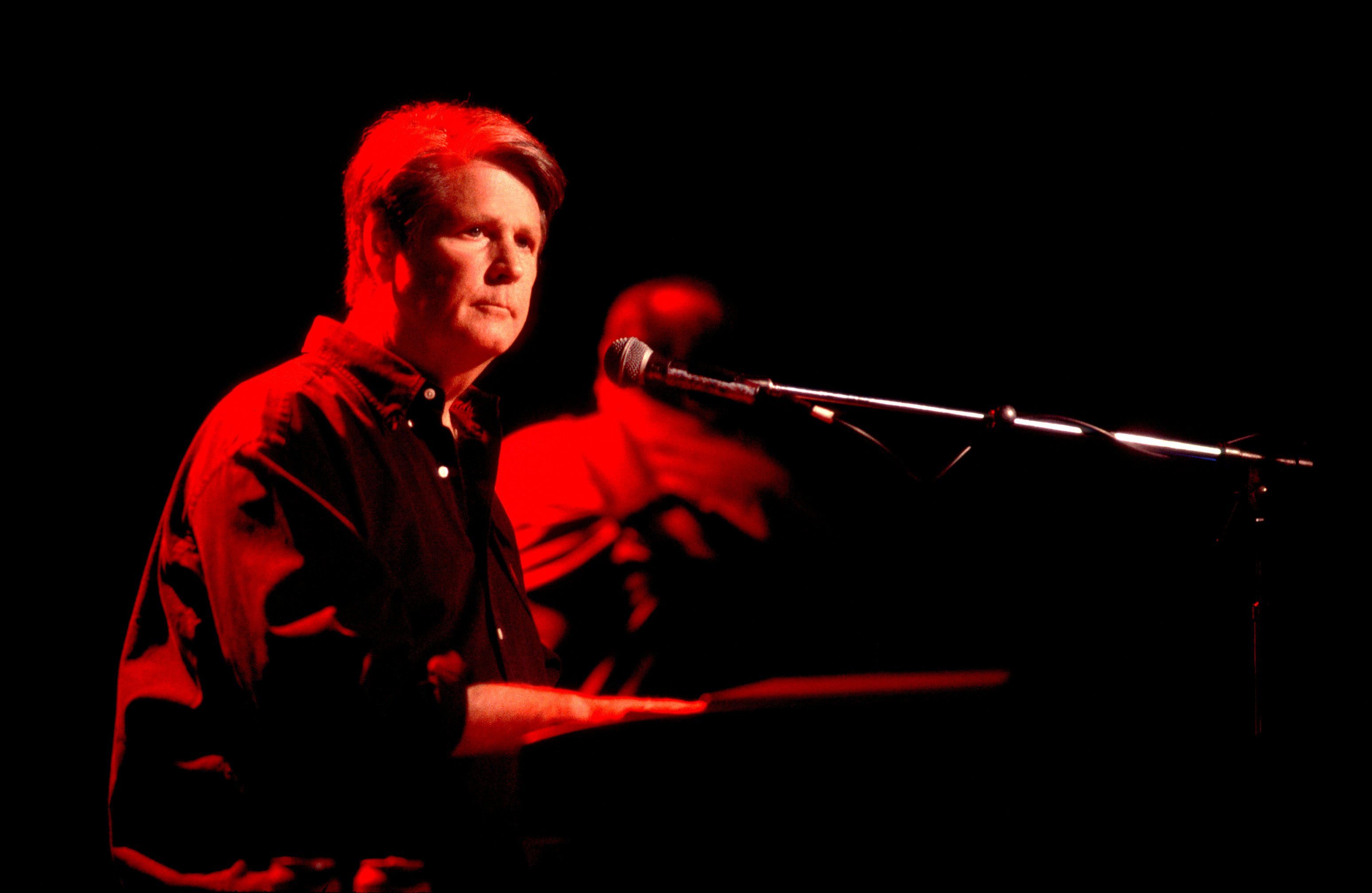 American Rock and Pop musician Brian Wilson plays keyboards as he performs