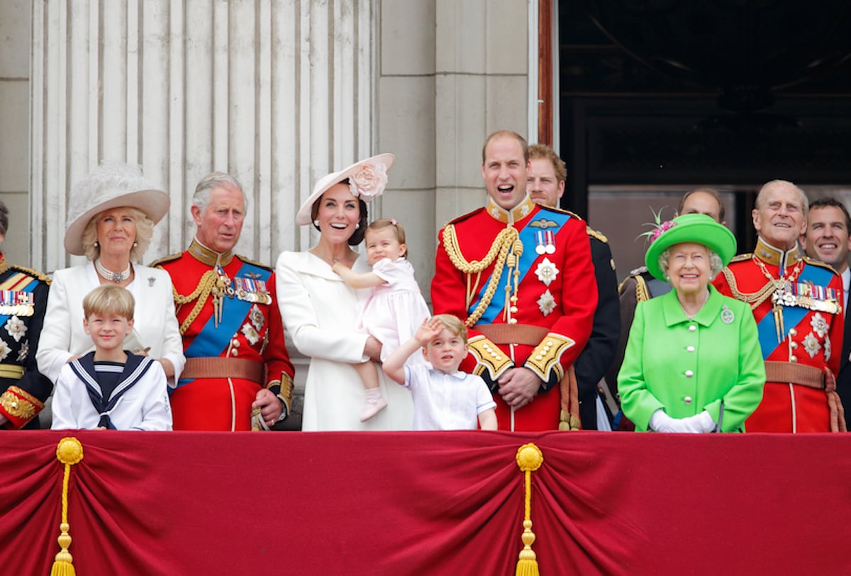 British royal family, whose body language doesn't typically including having arms crossed according to body language expert Judi James, stand on the balcony of Buckingham Palace
