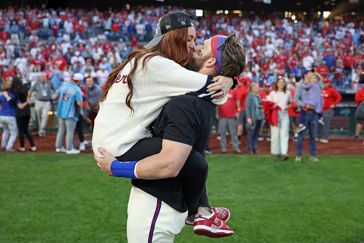 Bryce Harper kisses his wife, Kayla Harper who he met in high school, after defeating the Atlanta Braves in Game 4 of the NLDS