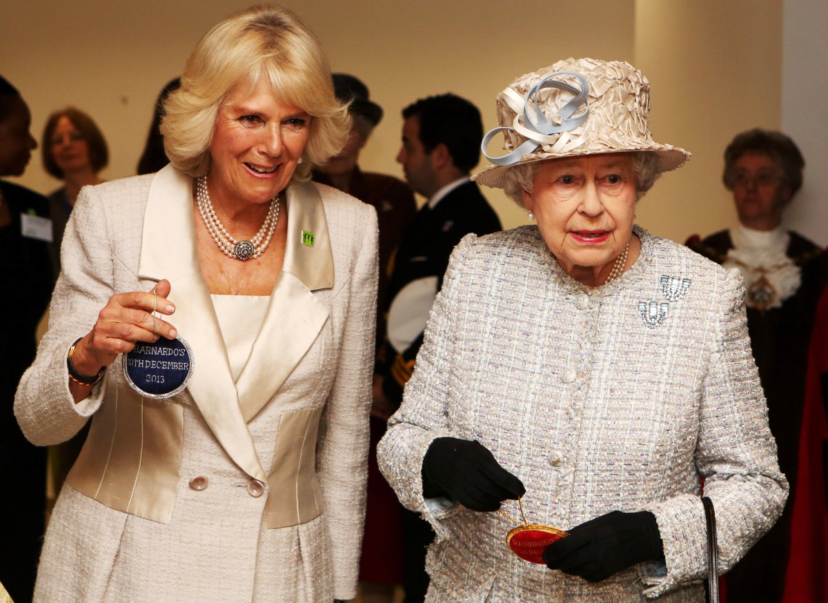 Camilla Parker Bowles, then Duchess of Cornwall, now queen consort and Queen Elizabeth II visit the new Barnardo's HQ in Barkingside on December 10, 2013 in London, England