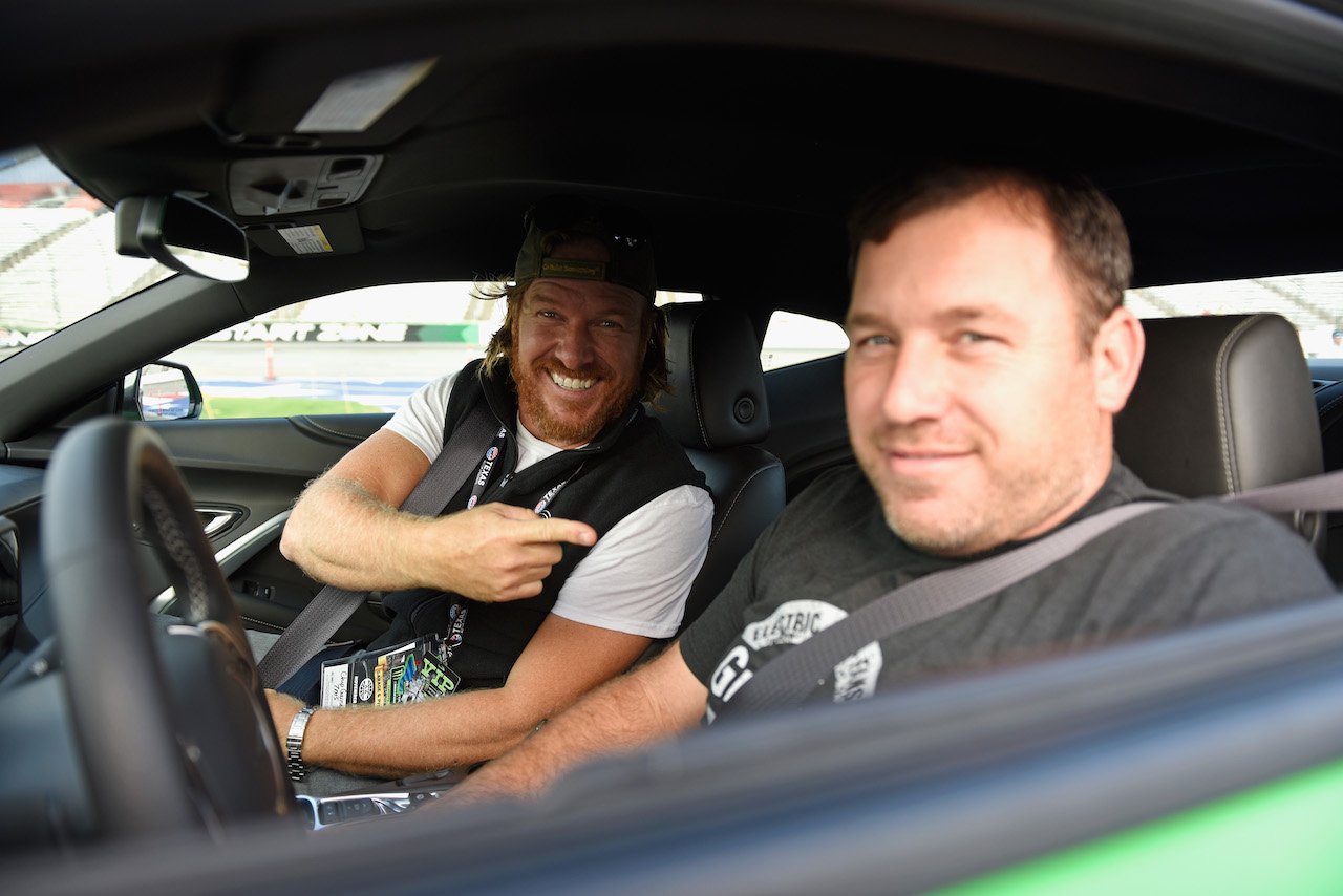 Chip Gaines sits with Ryan Newman, driver of the #31 Grainger Chevrolet, in the Monster Energy NASCAR Cup Series AAA Texas 500 pace car at Texas Motor Speedway on November 5, 2017.