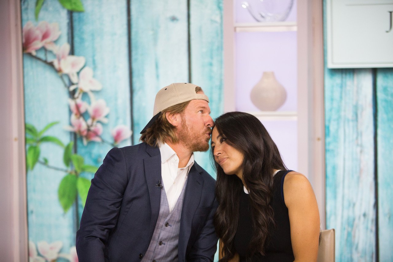 Chip Gaines kisses Joanna Gaines on the forehead in 2017. The couple said their castle restoration project reminded them of the 'beauty in forgotten places.'