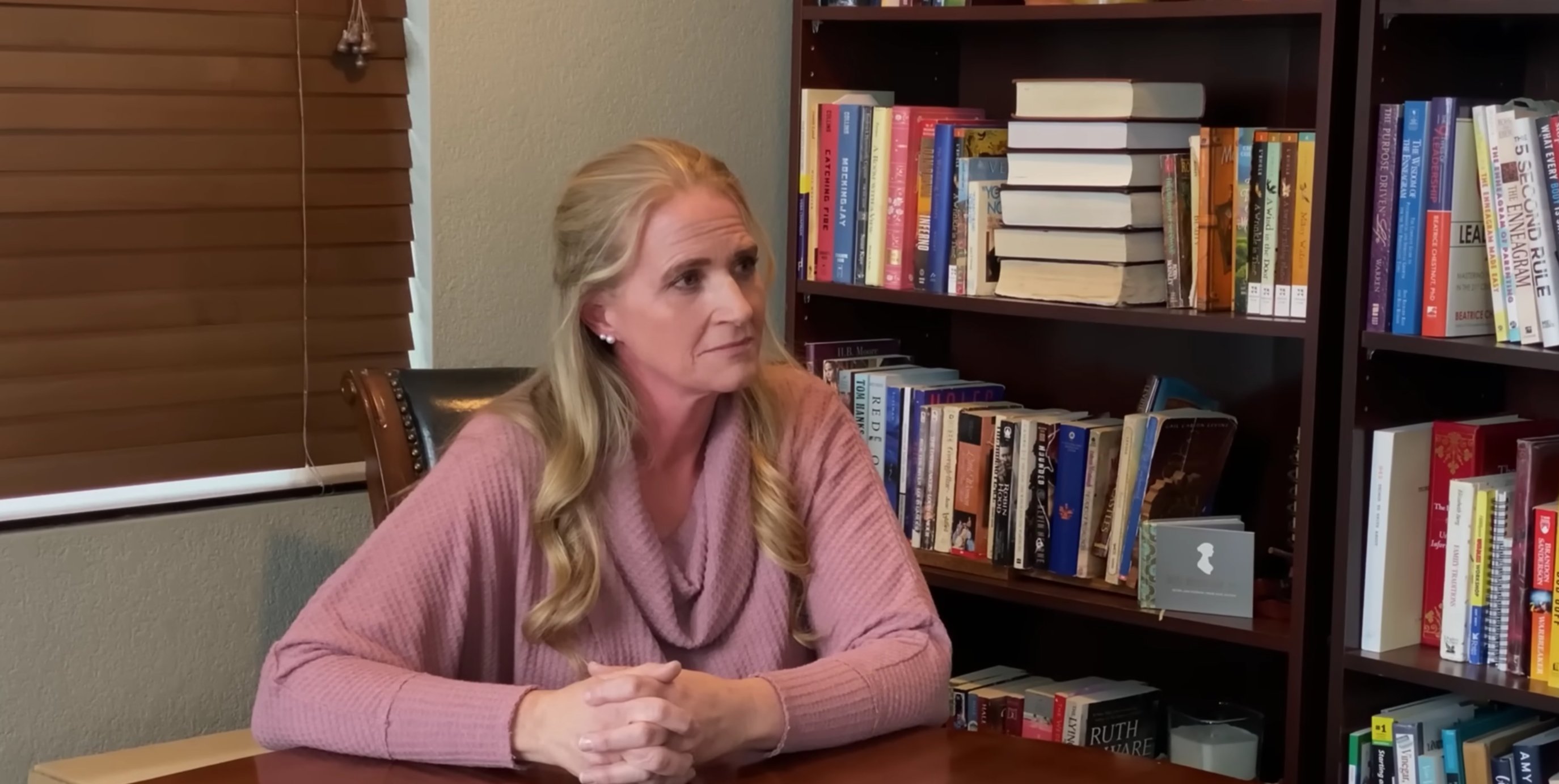 Christine Brown sits in front of her bookshelf in her office on 'Sister Wives' Season 17 on TLC.