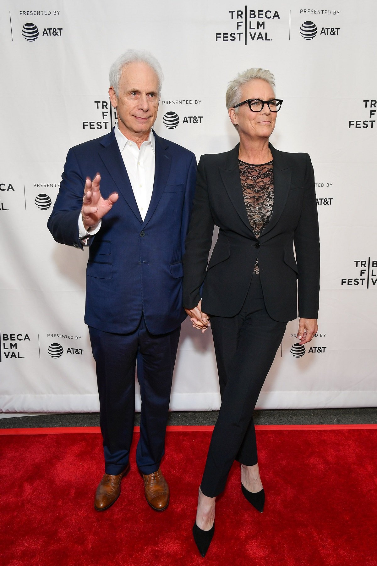 Christopher Guest and Jamie Lee Curtis hold hands on the carpet at the 'This Is Spinal Tap' 35th Anniversary during the Tribeca Film Festival